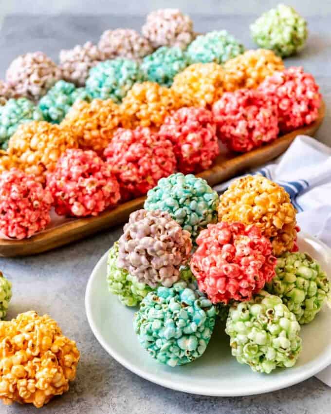 An image of Spring popcorn balls in bright rainbow colors for a fun, festive treat for Easter.