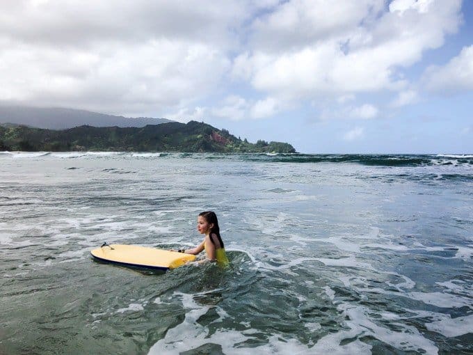 a girl with a surfboard in the water
