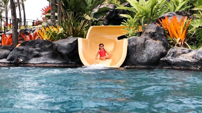 a girl coming down a water slide