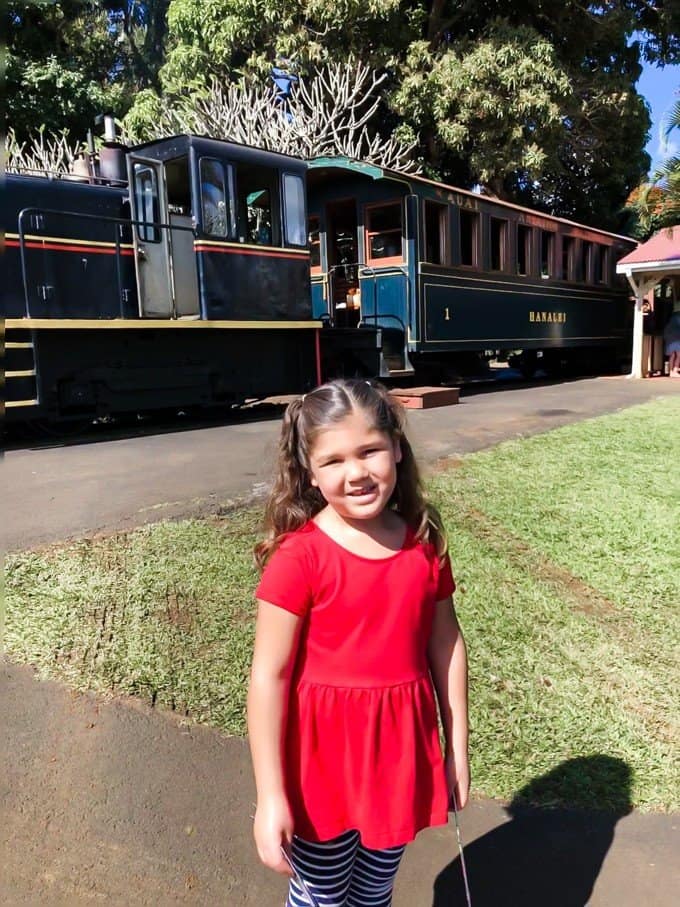 a girl posing in front of a train