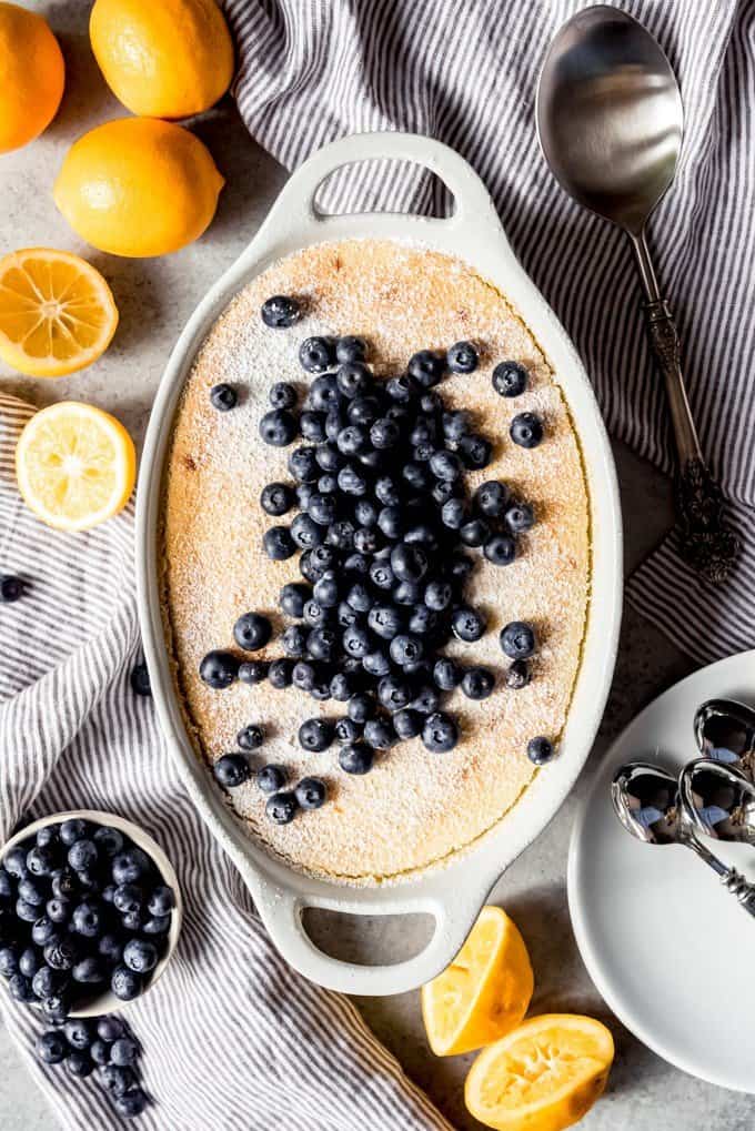 an aerial view of Meyer Lemon Pudding Cake with blueberries on top