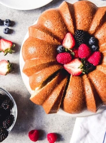sour cream pound cake filled with mixed berries and a slice cut