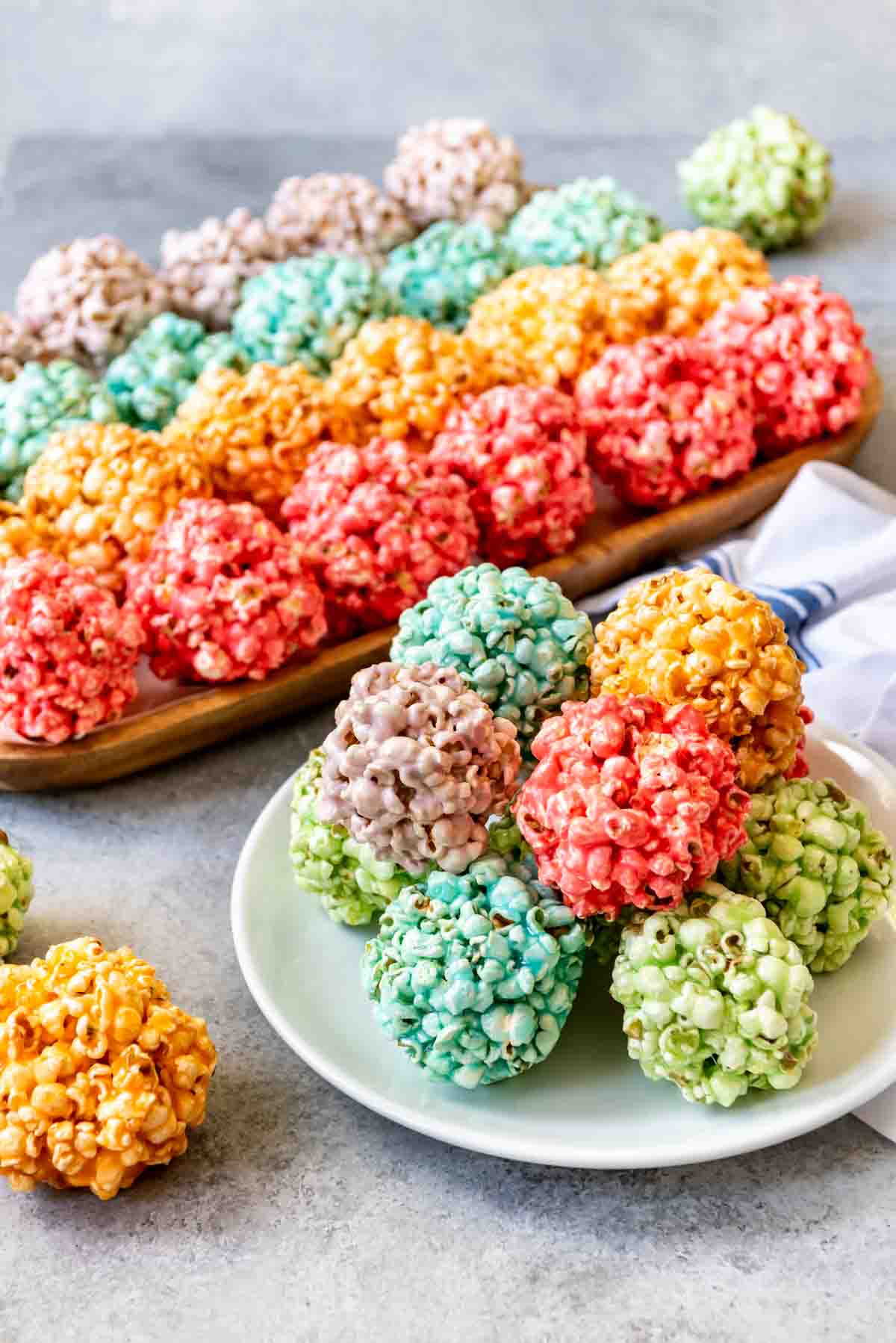 An image of Spring popcorn balls in bright rainbow colors for a fun, festive treat for Easter.