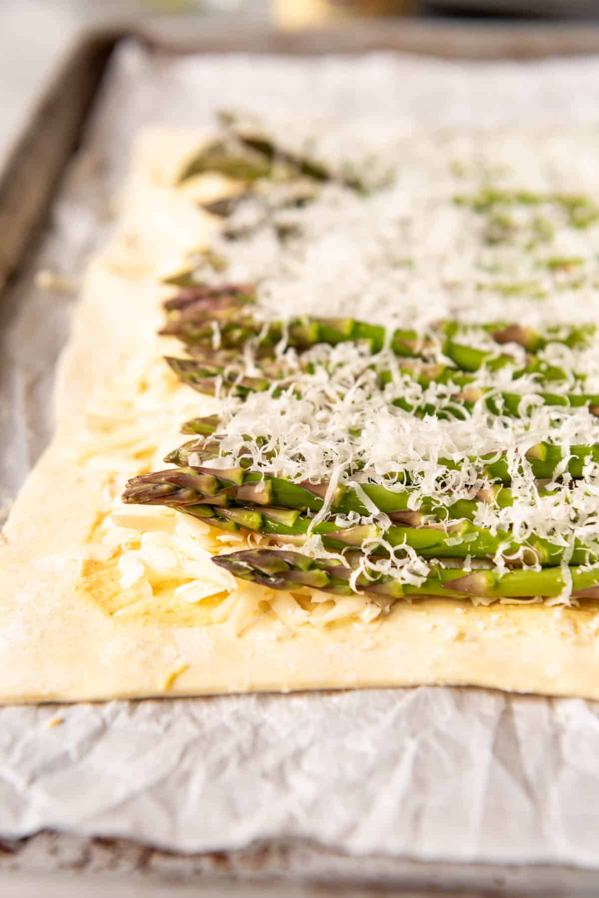 An image of asparagus sprinkled with Parmesan cheese.