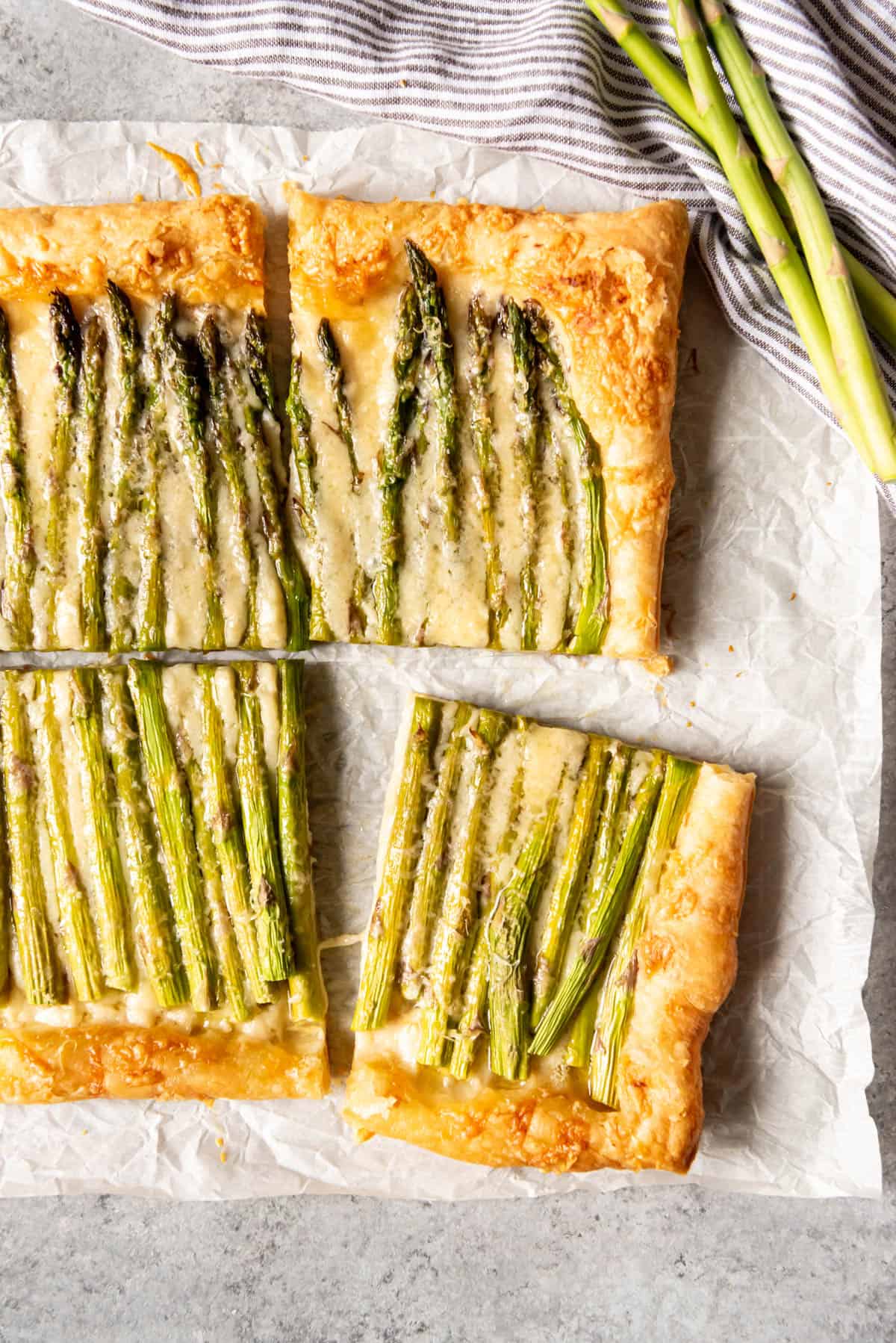 An image of an easy brunch appetizer made with puff pastry, cheese, dijon mustard, and asparagus.