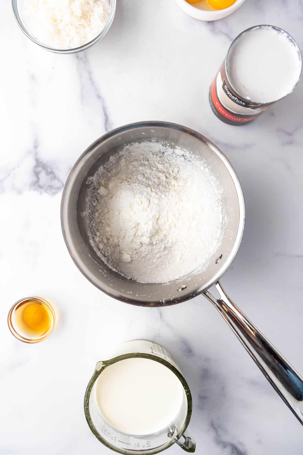 Combining sugar and cornstarch in a saucepan.