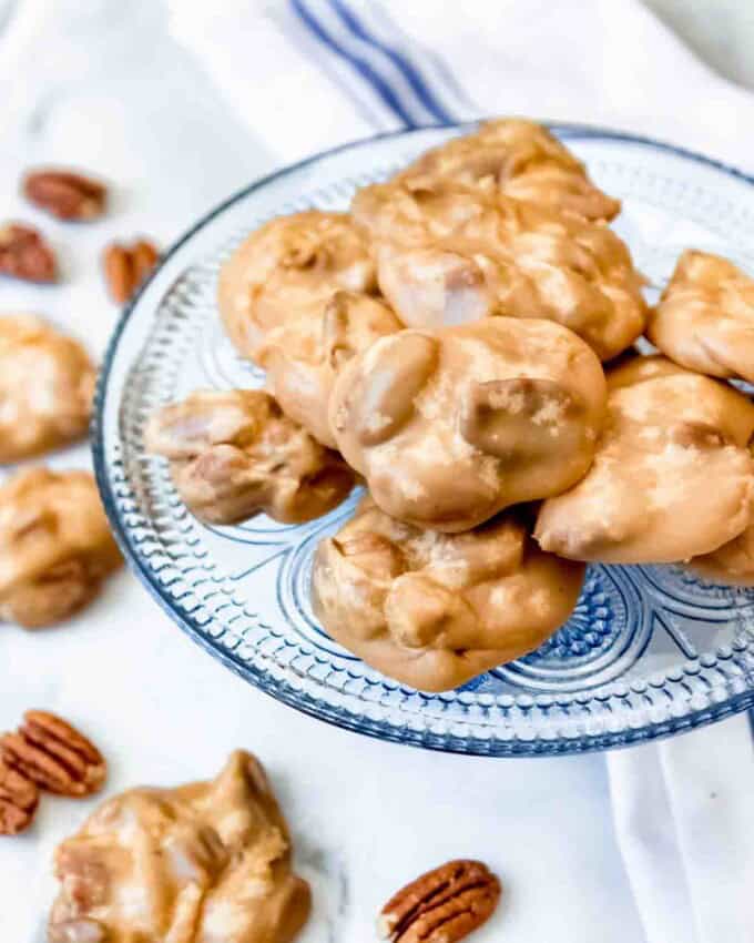 An image of pecan praline candy on a blue glass plate.