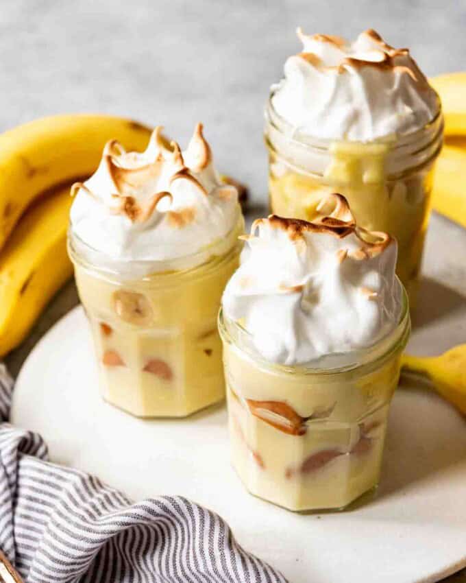 An image of three banana puddings with meringue on top.