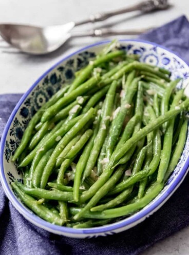 Tender-crisp Haricot Verts (French green beans) with Dijon Vinaigrette are a delicious and easy-fancy side dish that are perfect for serving alongside any holiday meal or Sunday supper.  They can be served warm or cold, making this a great option for picnics and summer barbecues!