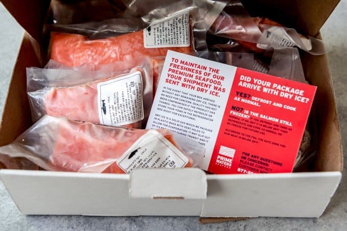 An image of a box full of frozen coho salmon fillets.