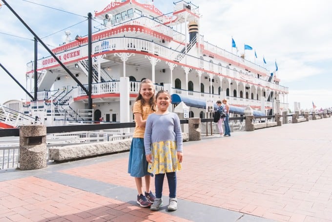 An image of two girls in front of the Georgia Queen riverboat. 