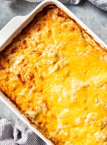 An overhead image of a large white pan of scalloped potatoes.