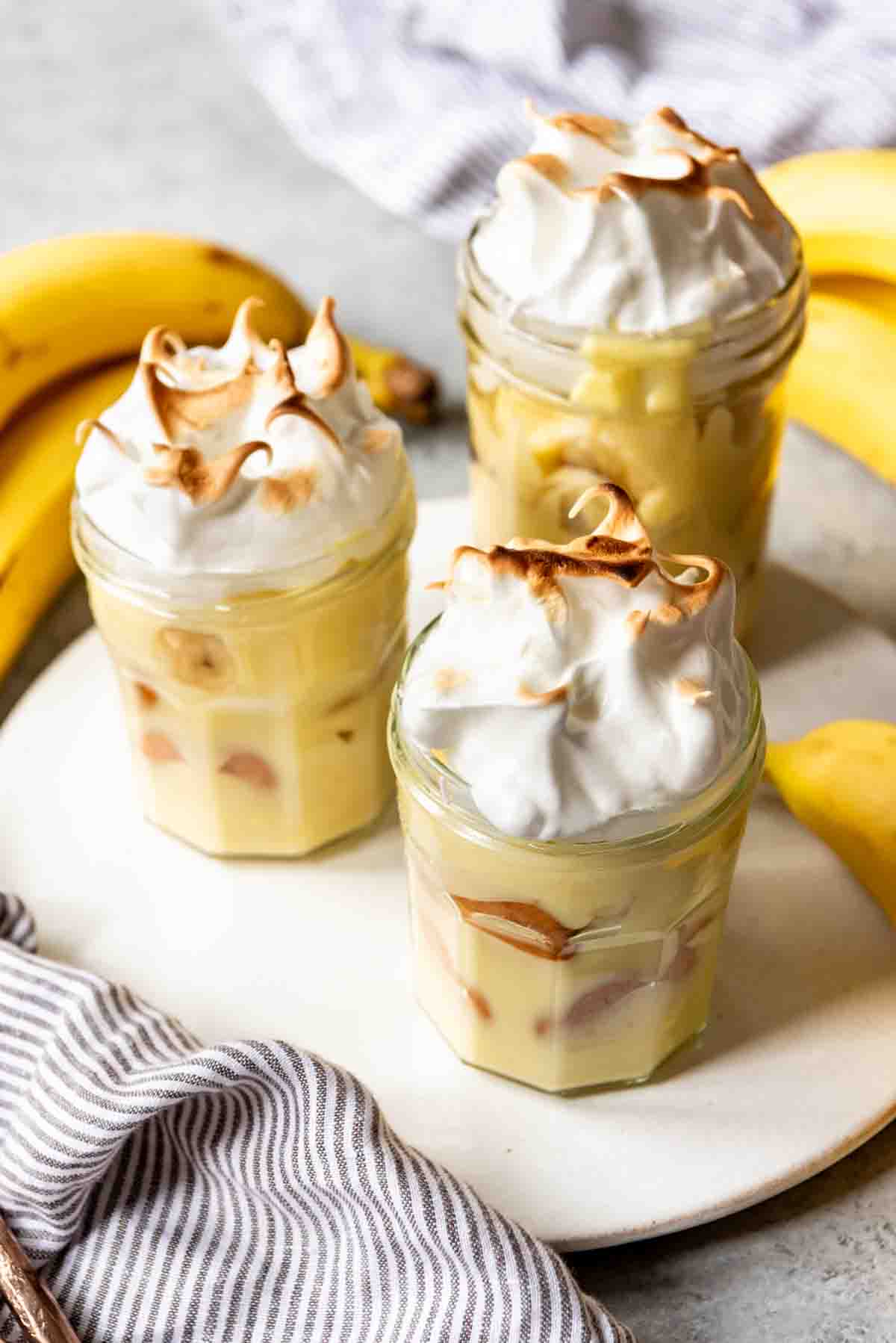 An image of three banana puddings with meringue on top.