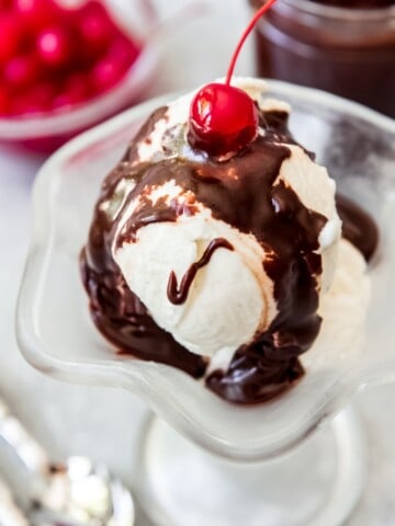 hot fudge over a scoop of vanilla ice cream and topped with a cherry