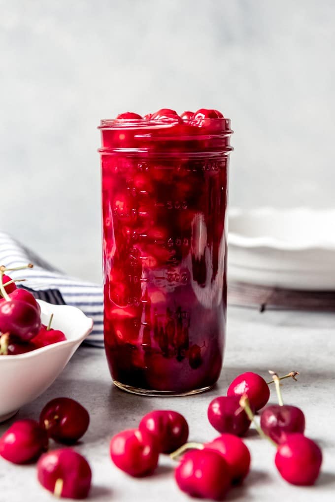 An image of a jar filled with homemade cherry pie filling made from canned tart red cherries.
