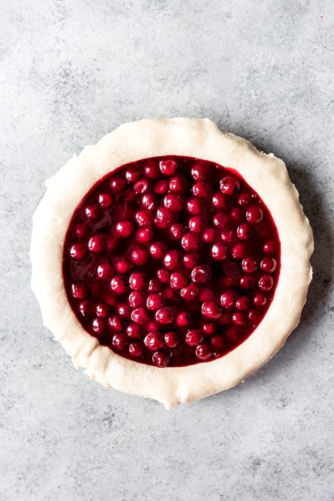 A pie crust filled with cherry pie filling.
