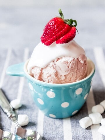 An image of a scoop of strawberry ice cream with homemade marshmallow topping.