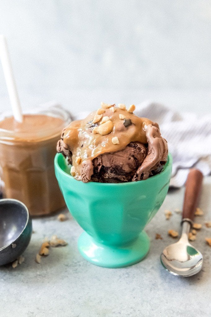 An image of a scoop of peanut butter ice cream topping over a scoop of chocolate ice cream.