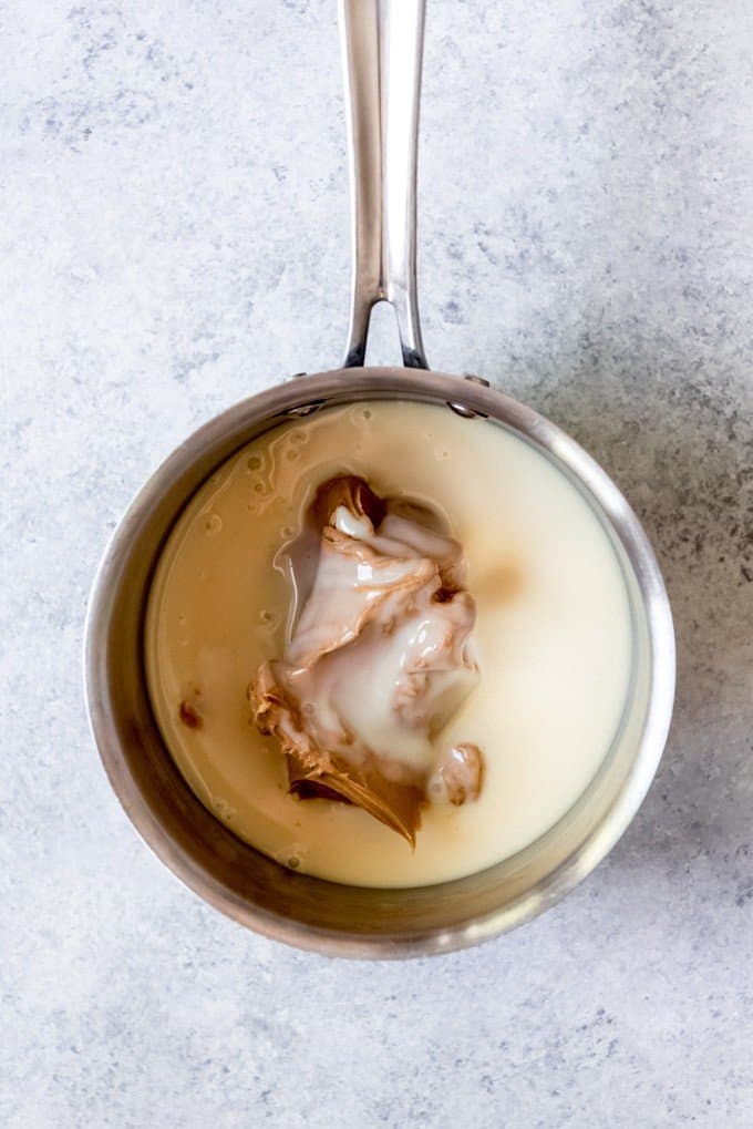 An image of a saucepan with sweetened condensed milk and peanut butter in it.