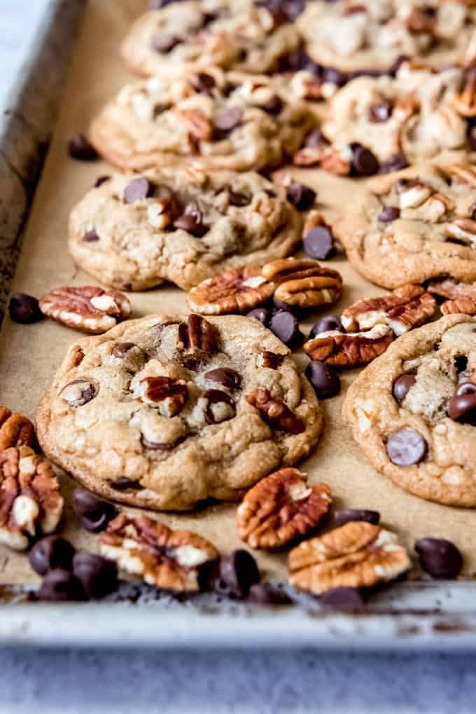 An image of pecan chocolate chip cookies on a baking sheet.