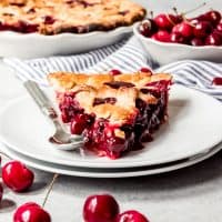 An image of a slice of homemade cherry pie.
