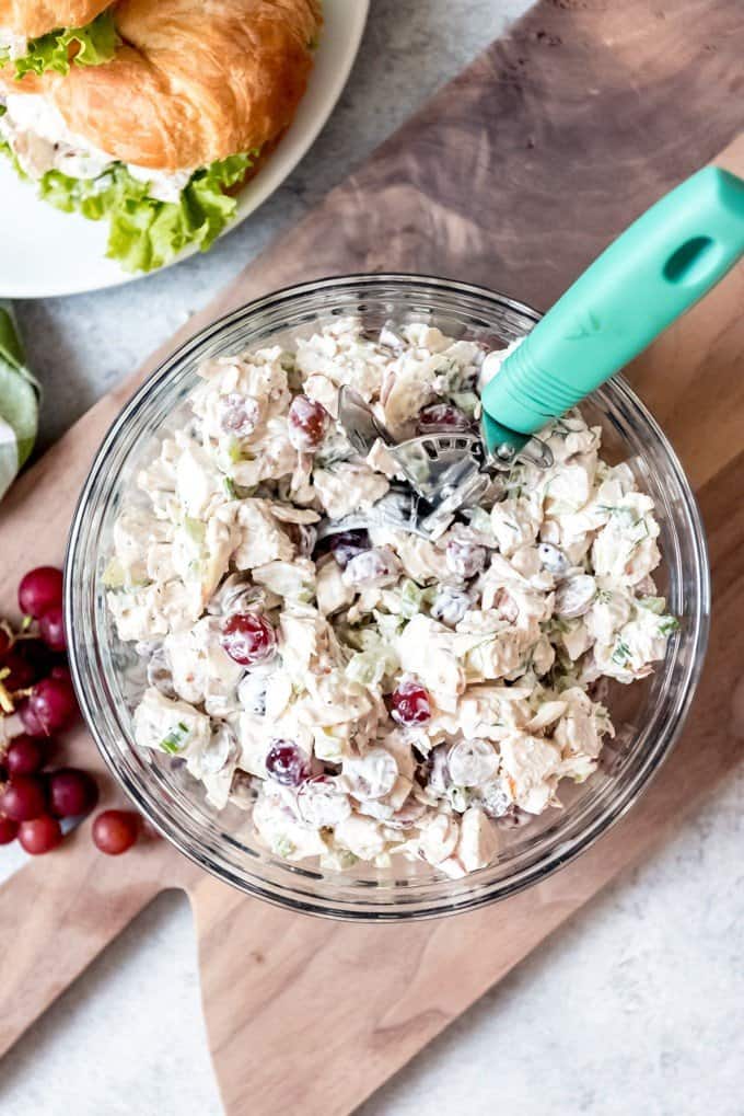 An image of a large bowl of homemade chicken salad with grapes, almonds, and celery in it.