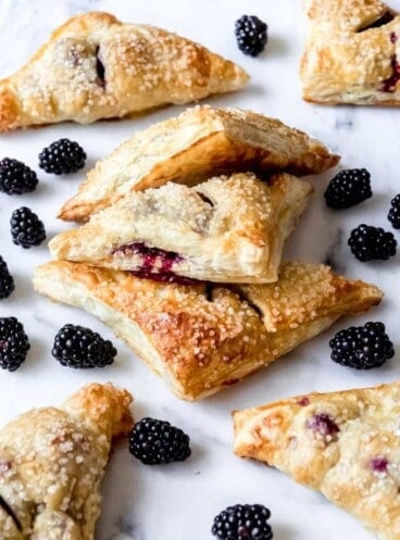 Blackberry turnovers with scattered blackberries around them