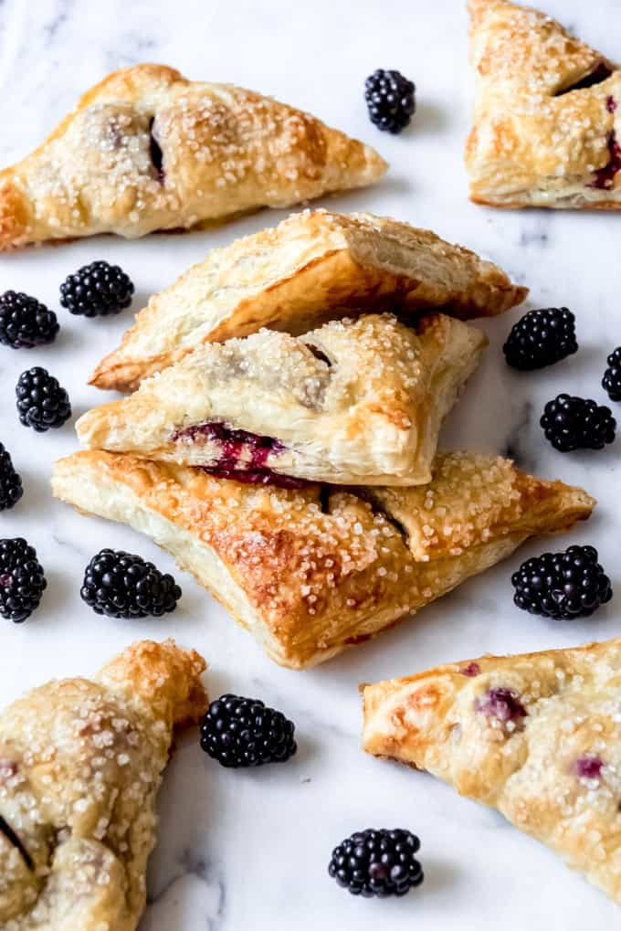 An image of homemade blackberry turnovers with coarse sugar on top.
