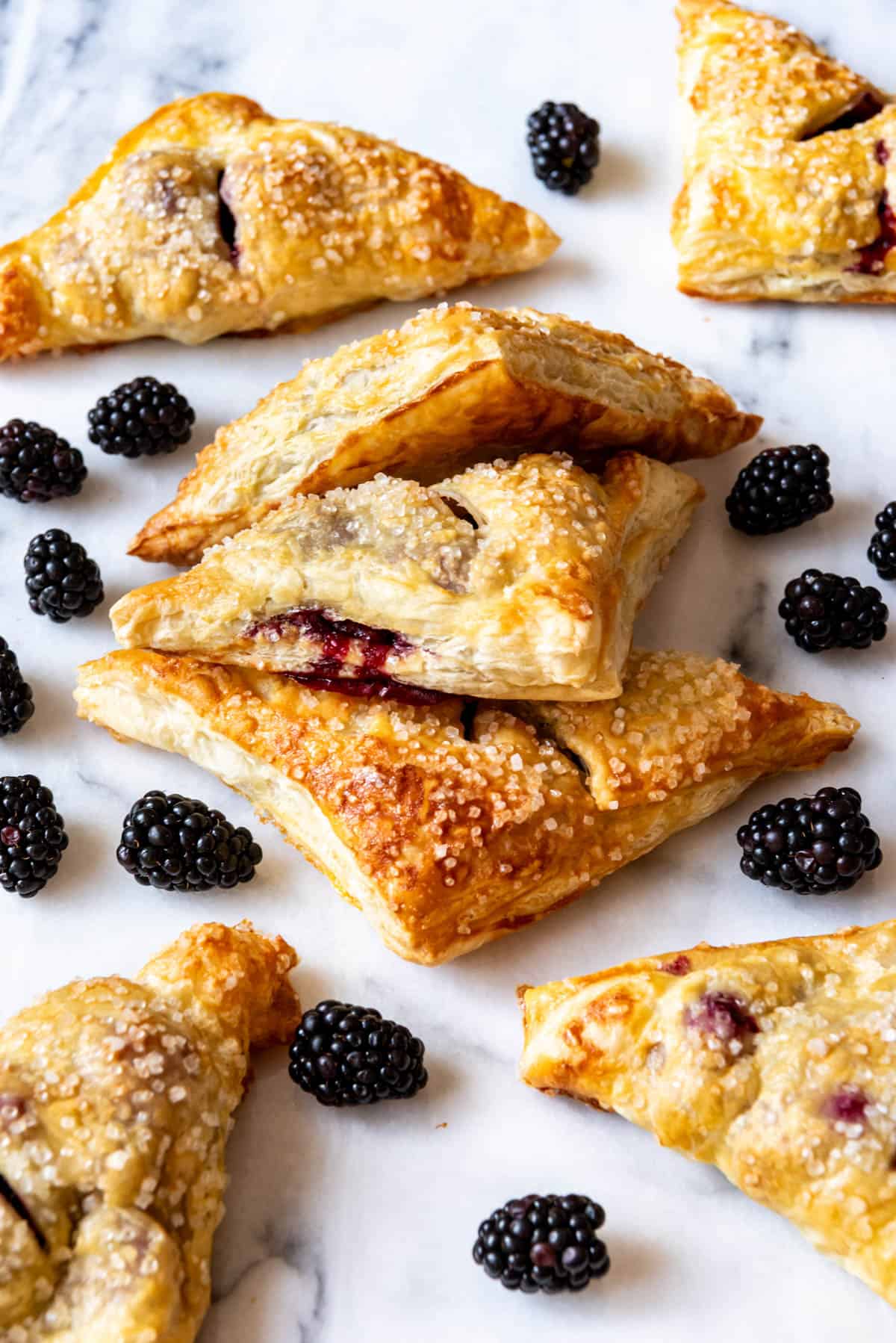 An image of homemade blackberry turnovers with coarse sugar on top.