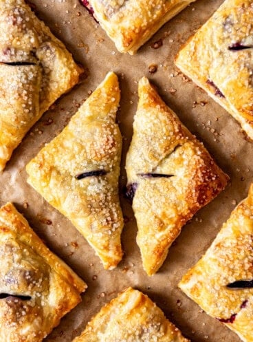 An overhead image of triangle shaped blackberry turnovers.