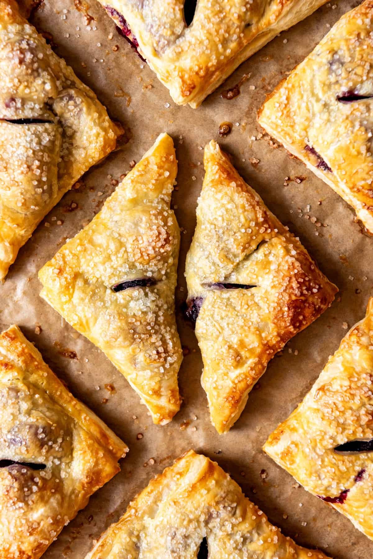 An overhead image of triangle shaped blackberry turnovers.