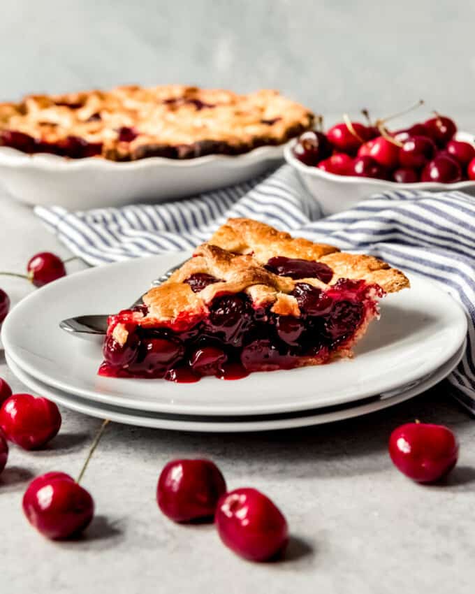 An image of a slice of homemade cherry pie on a plate.