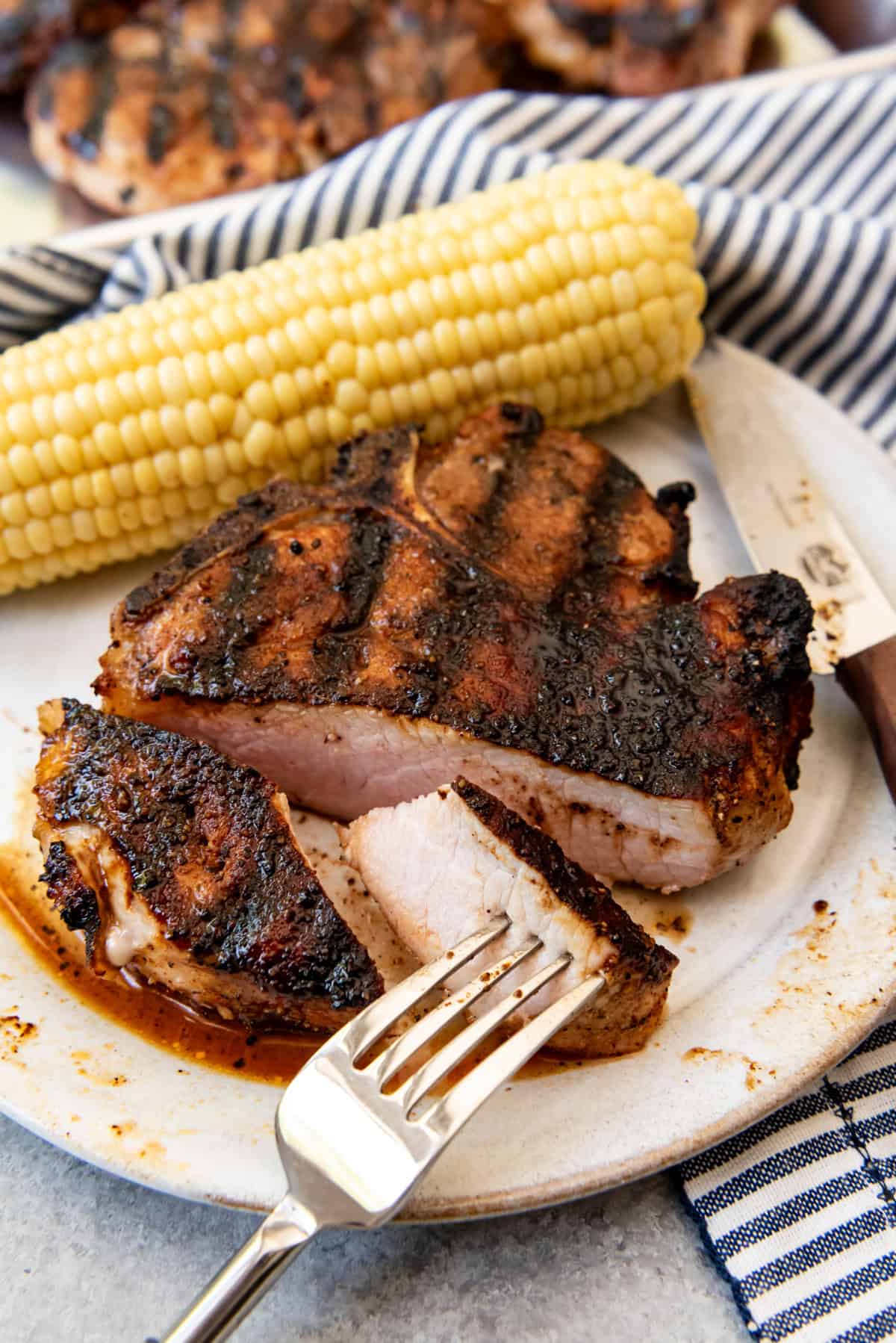 An image of a perfect grilled pork chop with sweet bbq rub.