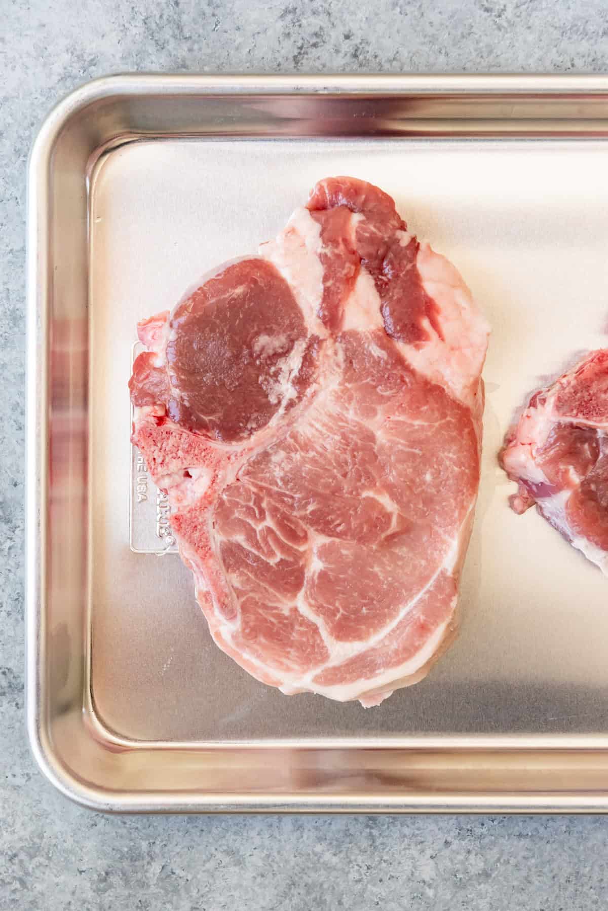 An image of a thick-cut bone-in pork loin chop.