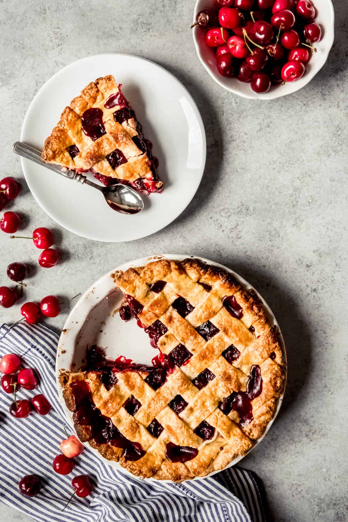 An image of a cherry pie with a slice taken out of it.