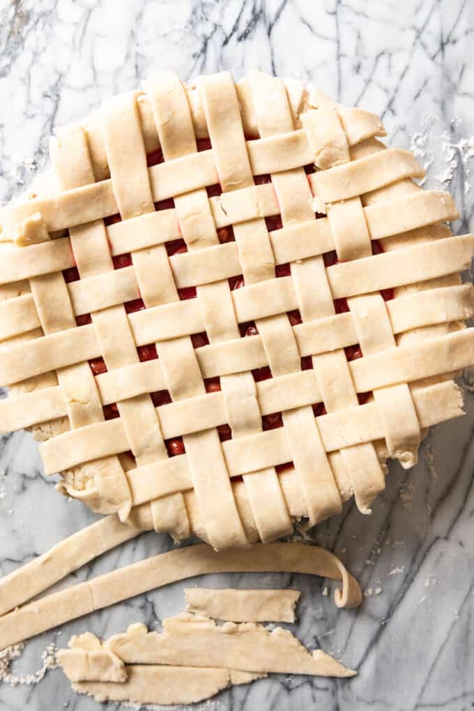 Lattice strips on top of a cherry pie.