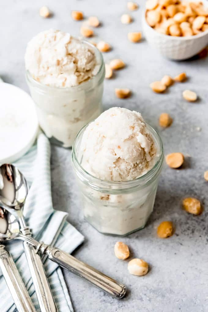 An image of two glass cups filled with scoops of homemade coconut macadamia nut ice cream.