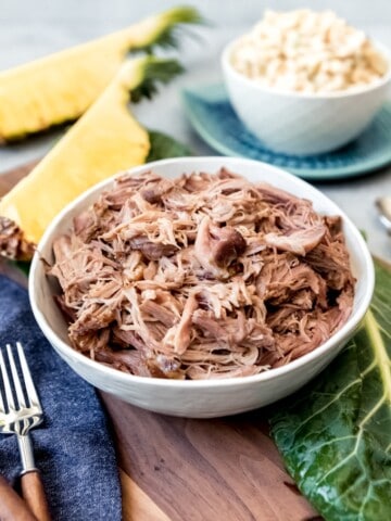 An image of a bowl of shredded kalua pork made in the slow cooker.
