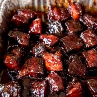An image of smoked pork belly burnt ends in a sweet honey barbecue sauce