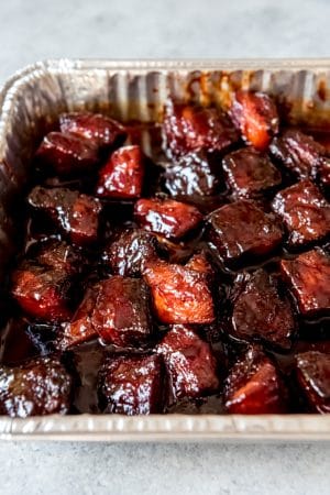 An image of smoked pork belly burnt ends in a sweet honey barbecue sauce