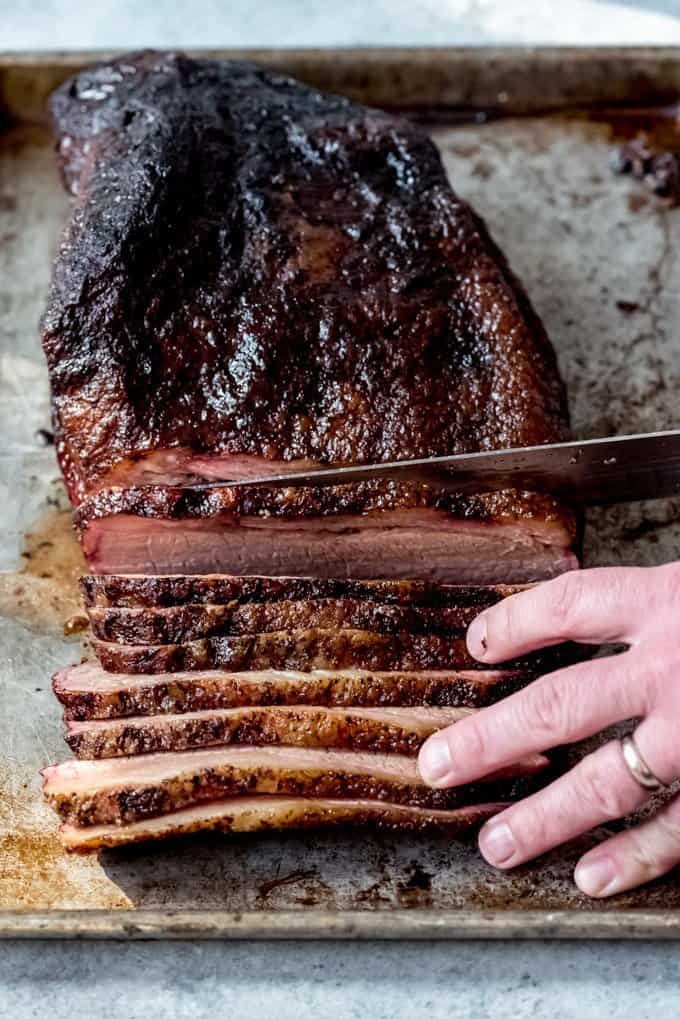 An image of a brisket smoked on a Traeger grill being sliced.