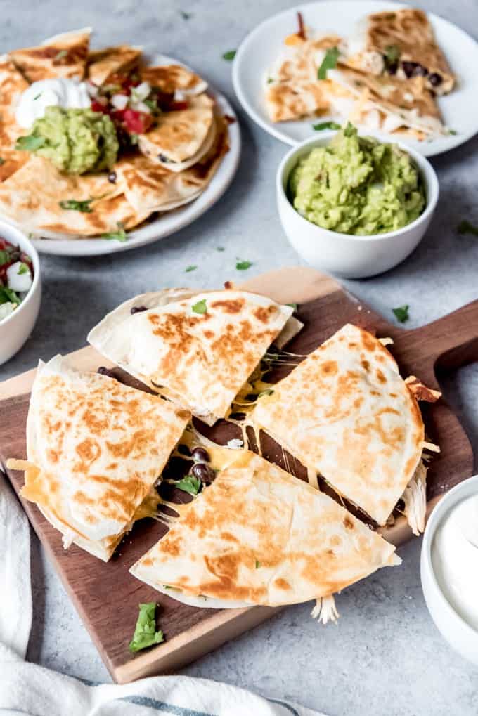 An image of quesadillas cut into triangles on a cutting board.