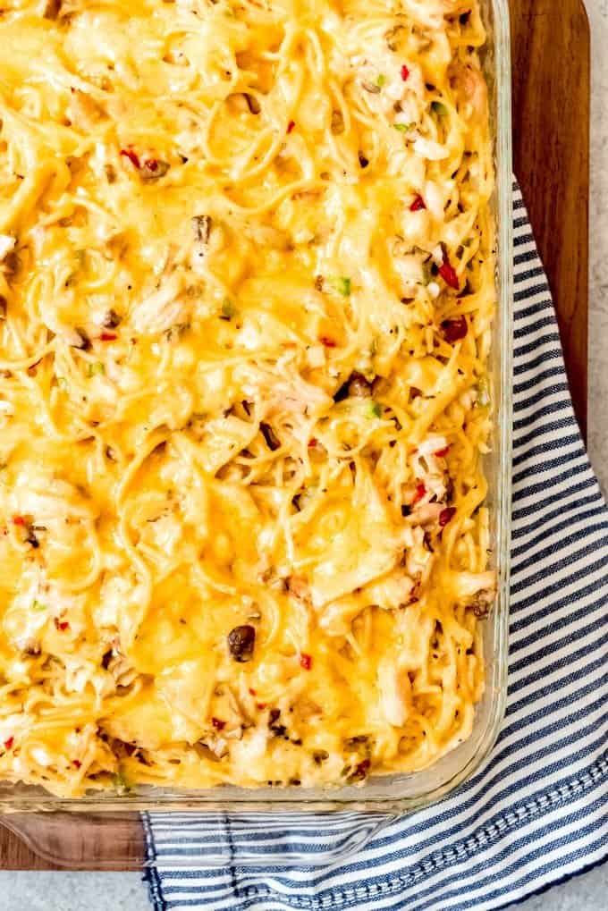 An image of a cheesy, hot, Chicken Spaghetti Casserole made with shredded Costco rotisserie chicken meat.