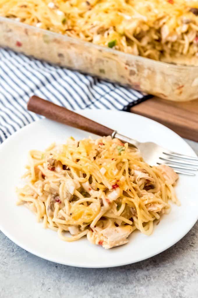 An image of a plate of an easy weeknight pasta dinner with Costco rotisserie chicken, spaghetti noodles, pimentos, green bell pepper, mushrooms, and cheese.