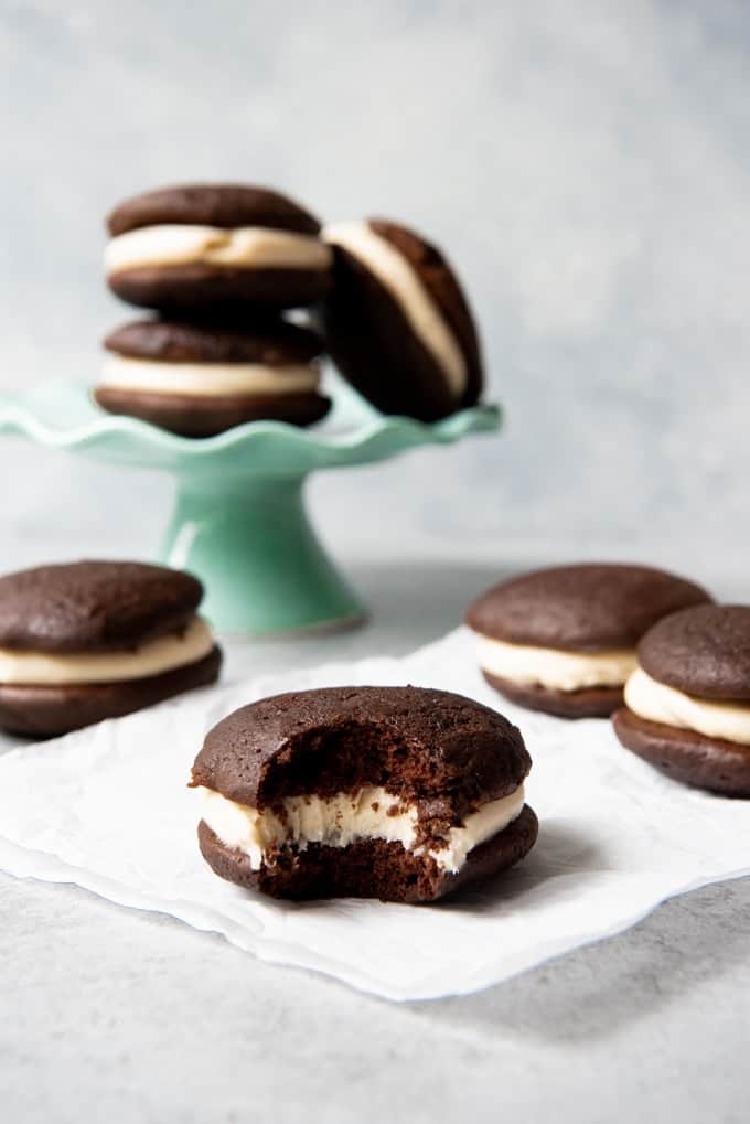 An image of homemade whoopie pies with a bite taken out of one.