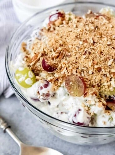 An image of a creamy grape salad with brown sugar pecan topping.