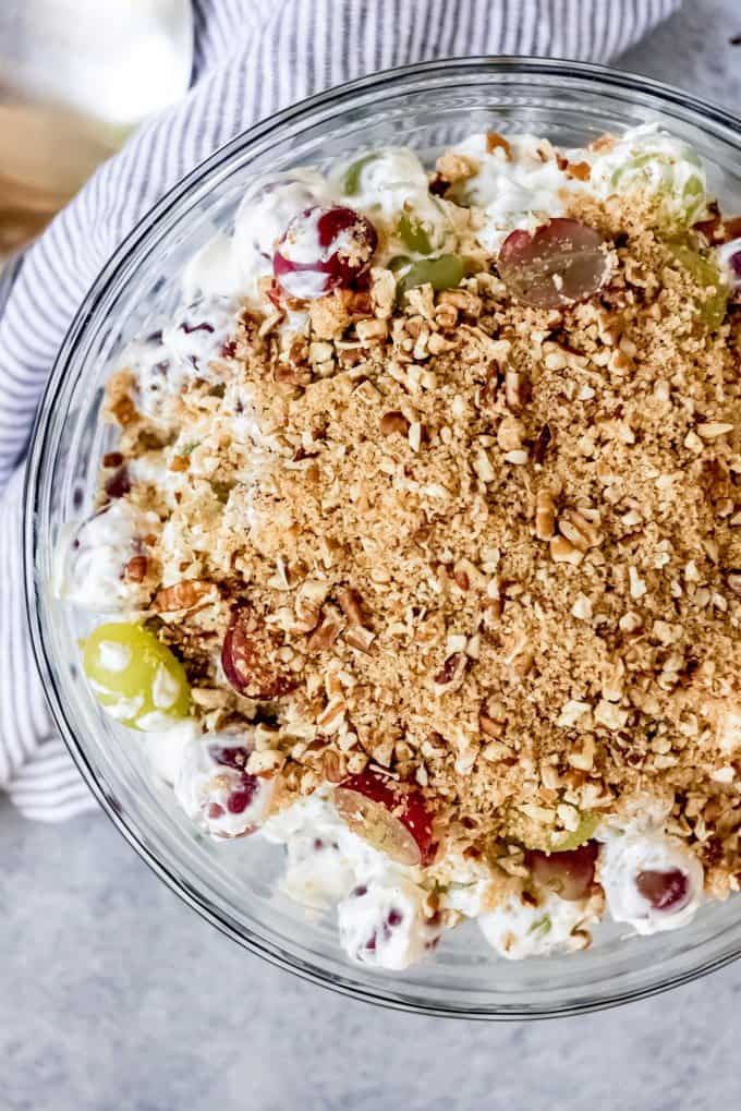 An image of a refreshing dessert salad made with grapes, cream cheese, sour cream, sugar, pecans and vanilla.