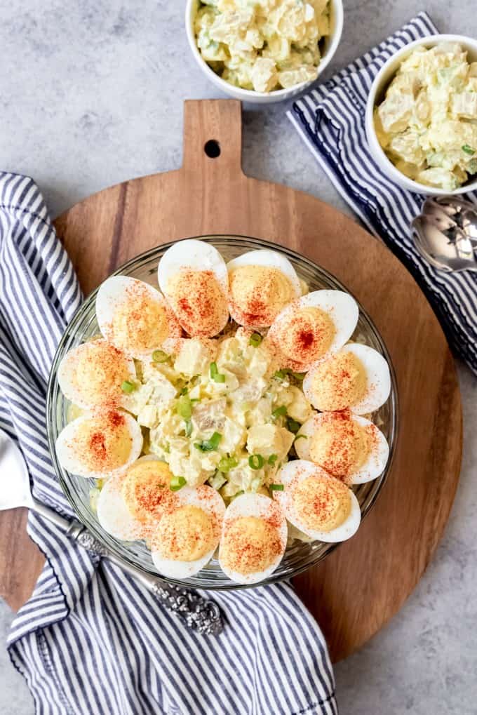An image of an old-fashioned potato salad recipe topped with deviled eggs.