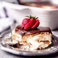 An image of a piece of no-bake chocolate eclair cake with a sliced strawberry on top.