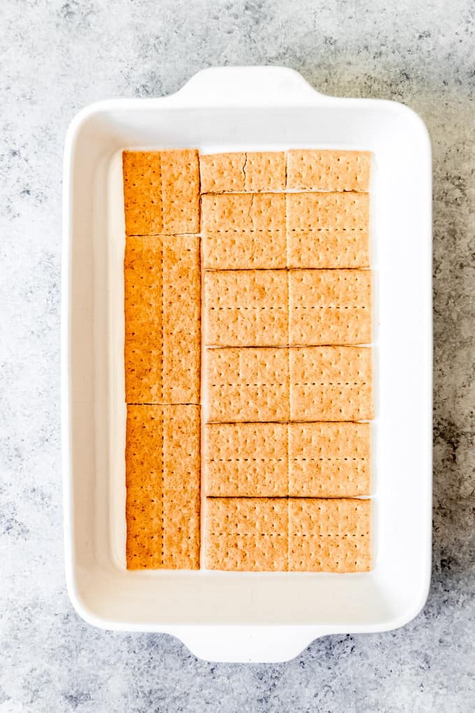 An image of graham cracker squares arranged in the bottom of a 9x13-inch baking dish.